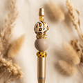 Close-up of the leopard-print, taupe, and gold bead details